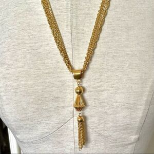 Gold tone multi chain tassel necklace
